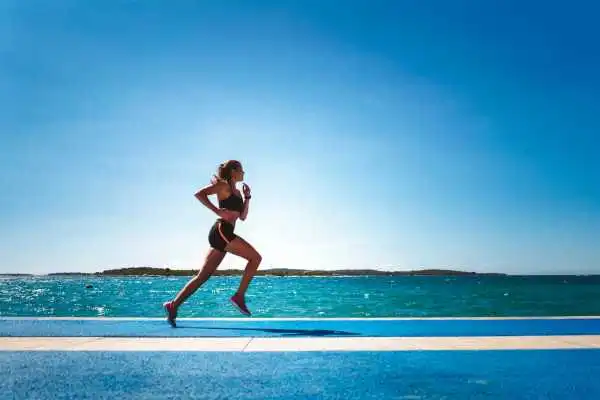 Woman running showing strong leg muscle Scotland